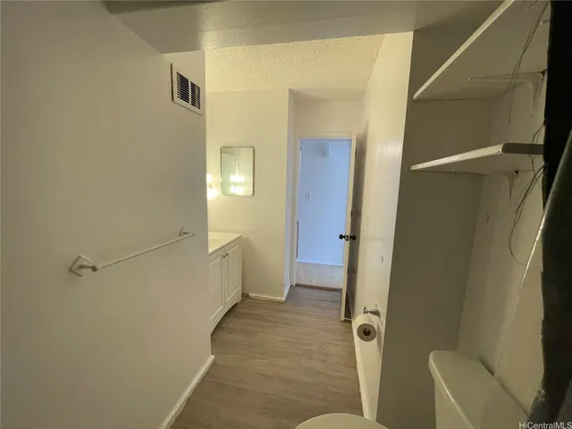 a bathroom with a toilet and a rug