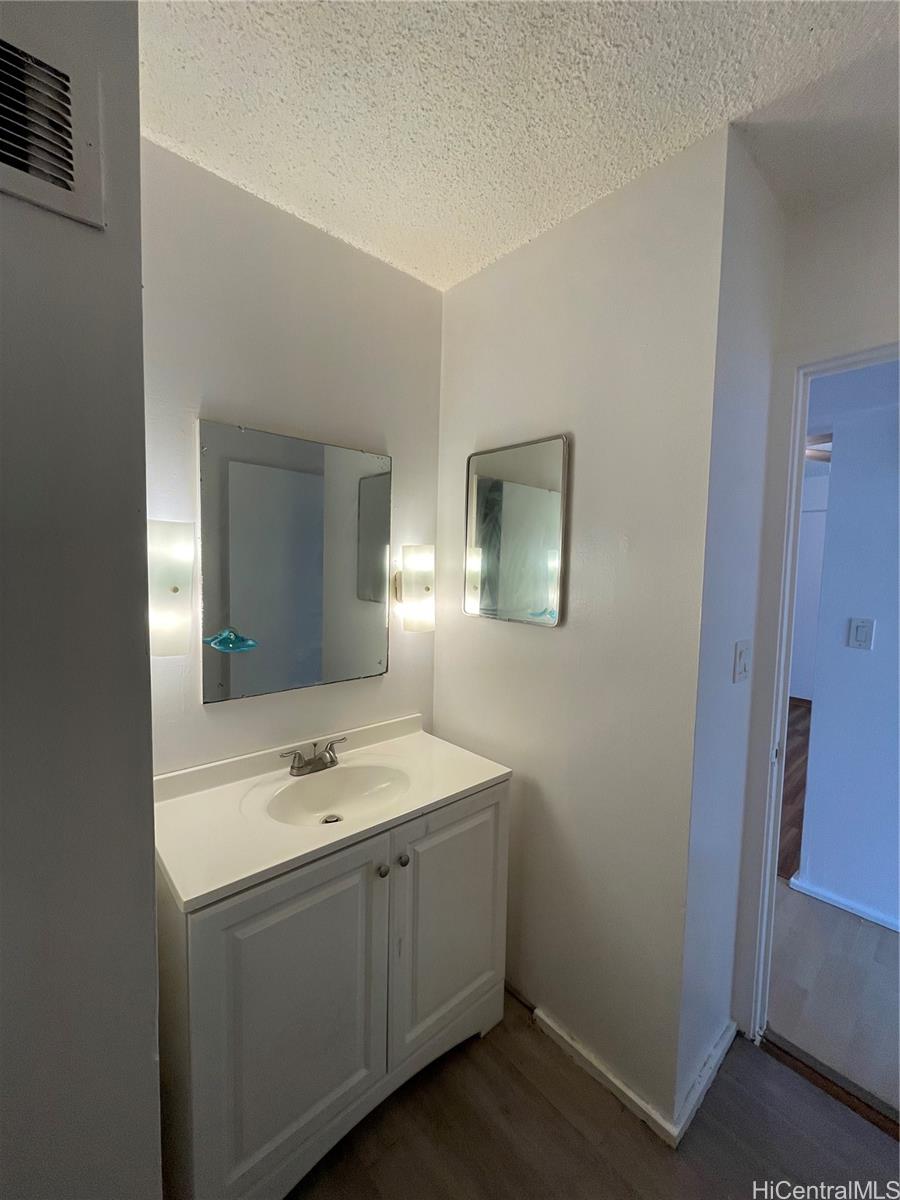 1619 Kamamalu Avenue, Unit 102 Honolulu, HI 96813 - Photo 13 of 18 a bathroom with a sink and a mirror