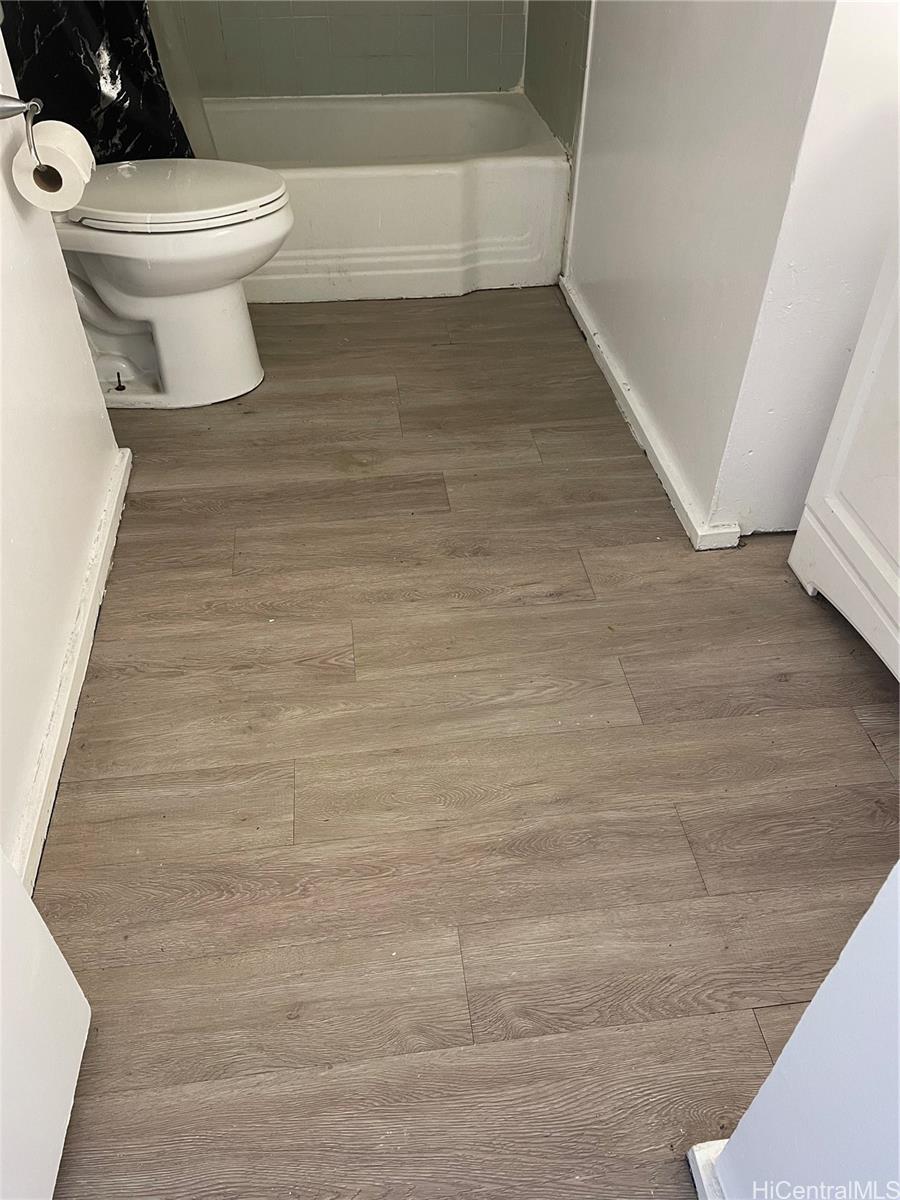 1619 Kamamalu Avenue, Unit 102 Honolulu, HI 96813 - Photo 14 of 18 a bathroom with a toilet and a rug