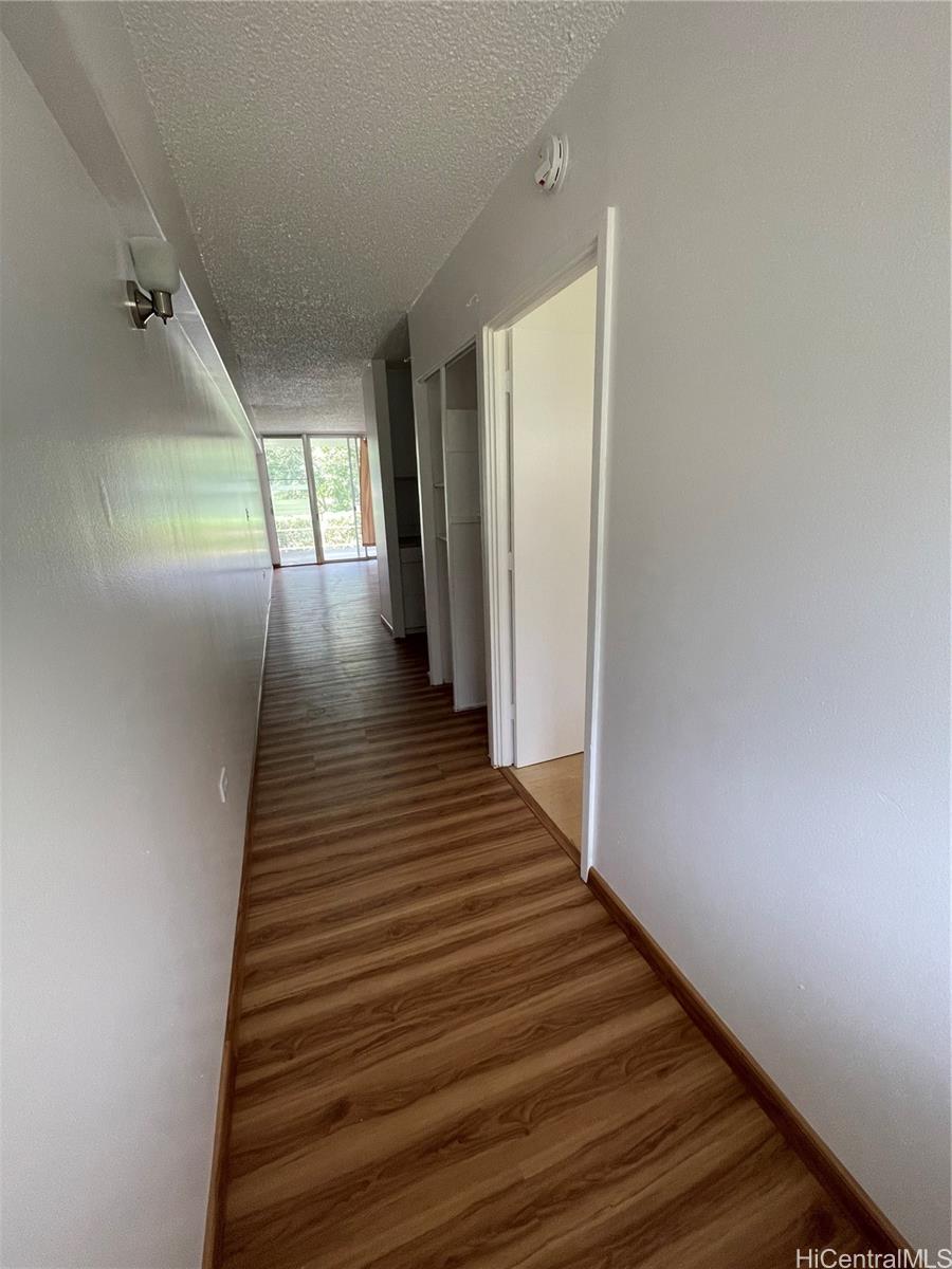 1619 Kamamalu Avenue, Unit 102 Honolulu, HI 96813 - Photo 4 of 18 a view of a hallway with wooden floor and staircase