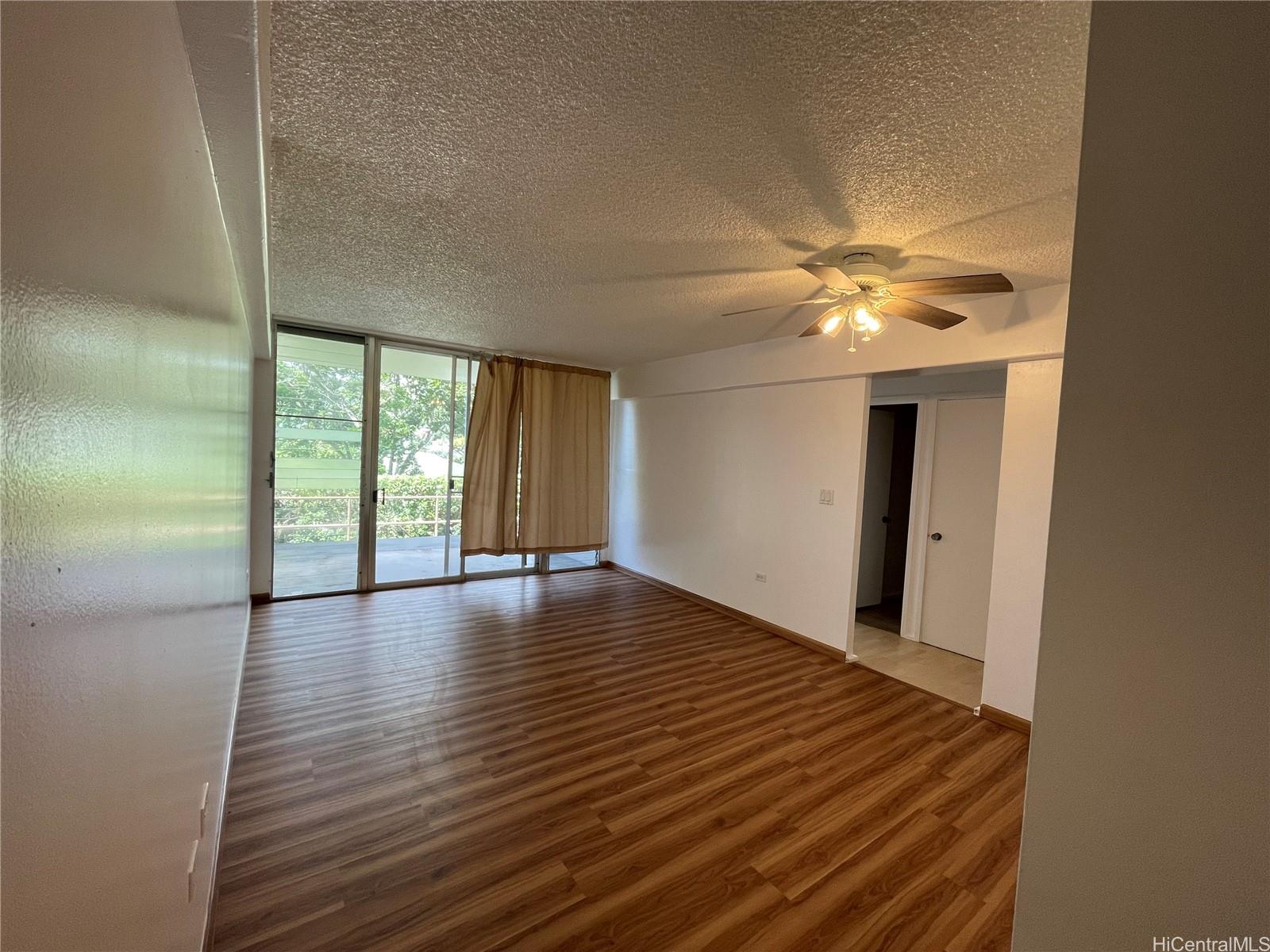 1619 Kamamalu Avenue, Unit 102 Honolulu, HI 96813 - Photo 7 of 18 a view of an empty room with window and wooden floor