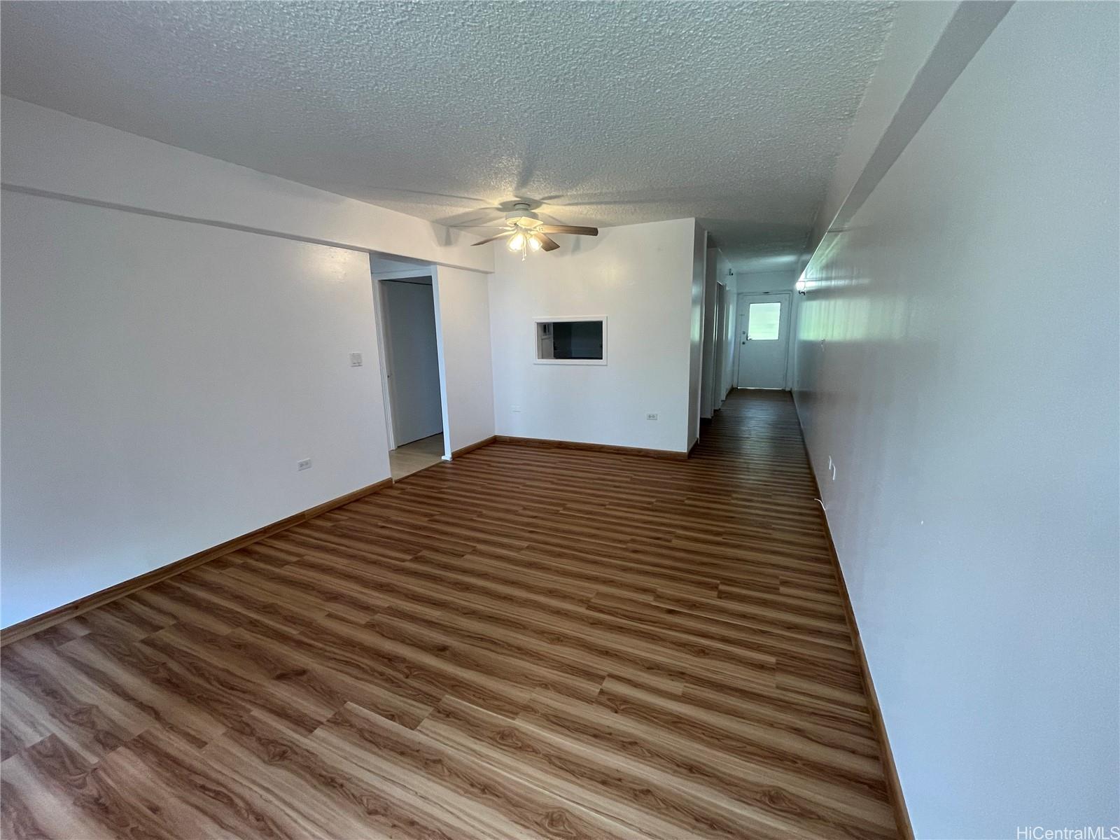 1619 Kamamalu Avenue, Unit 102 Honolulu, HI 96813 - Photo 8 of 18 a view of a hallway with wooden floor and staircase