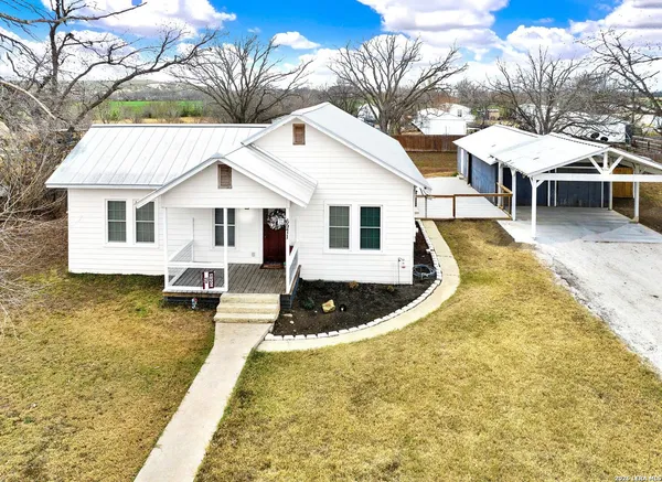 a view of a house with pool and deck