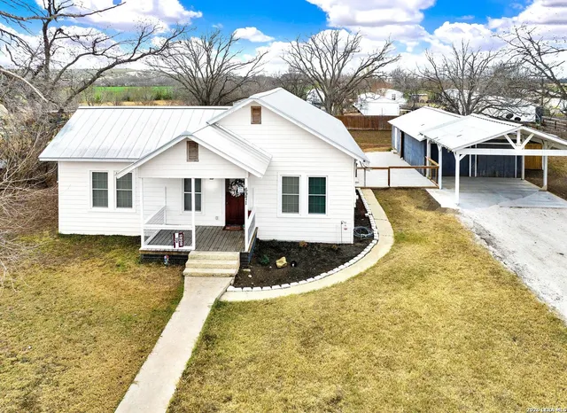 a view of a house with pool and deck