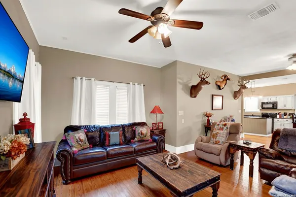 a living room with furniture and wooden floor