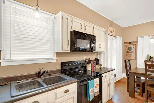 a kitchen with stainless steel appliances a sink a stove and cabinets