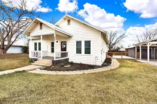 a view of a house with snow on the road