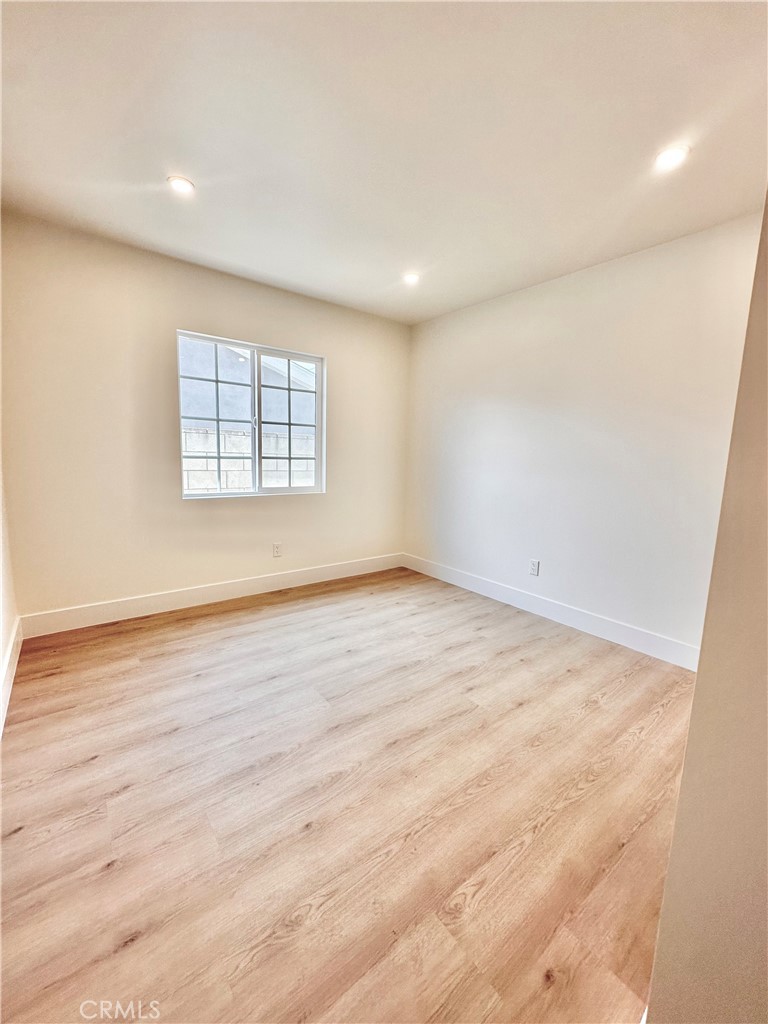 1543 Delford Avenue, Unit 1/2 Duarte, CA 91010 - Photo 13 of 16 an empty room with wooden floor and windows