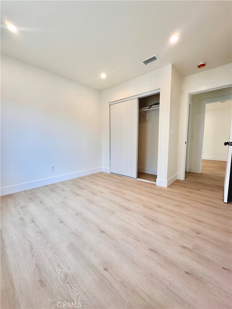 1543 Delford Avenue, Unit 1/2 Duarte, CA 91010 - Photo 14 of 16 an empty room with wooden floor and bathroom view