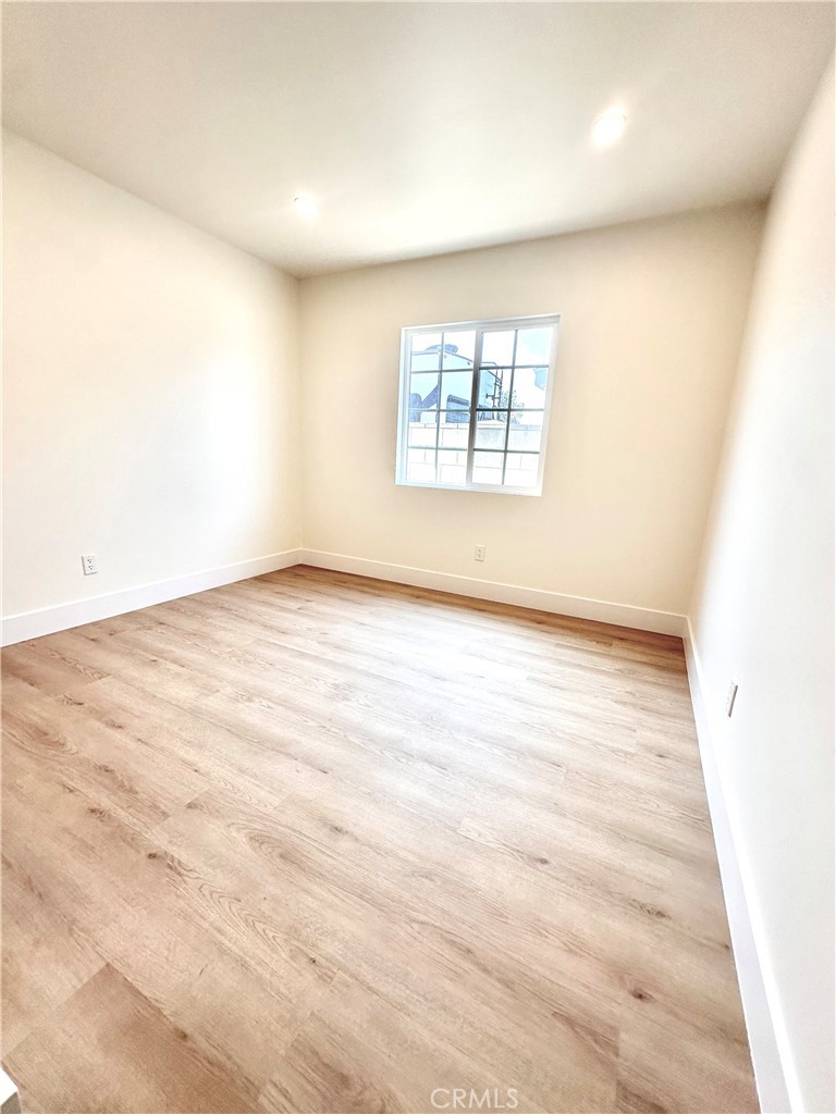 1543 Delford Avenue, Unit 1/2 Duarte, CA 91010 - Photo 15 of 16 an empty room with wooden floor and windows