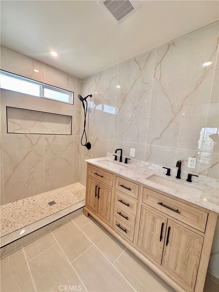 1543 Delford Avenue, Unit 1/2 Duarte, CA 91010 - Photo 8 of 16 a bathroom with a double vanity sink a large mirror and shower