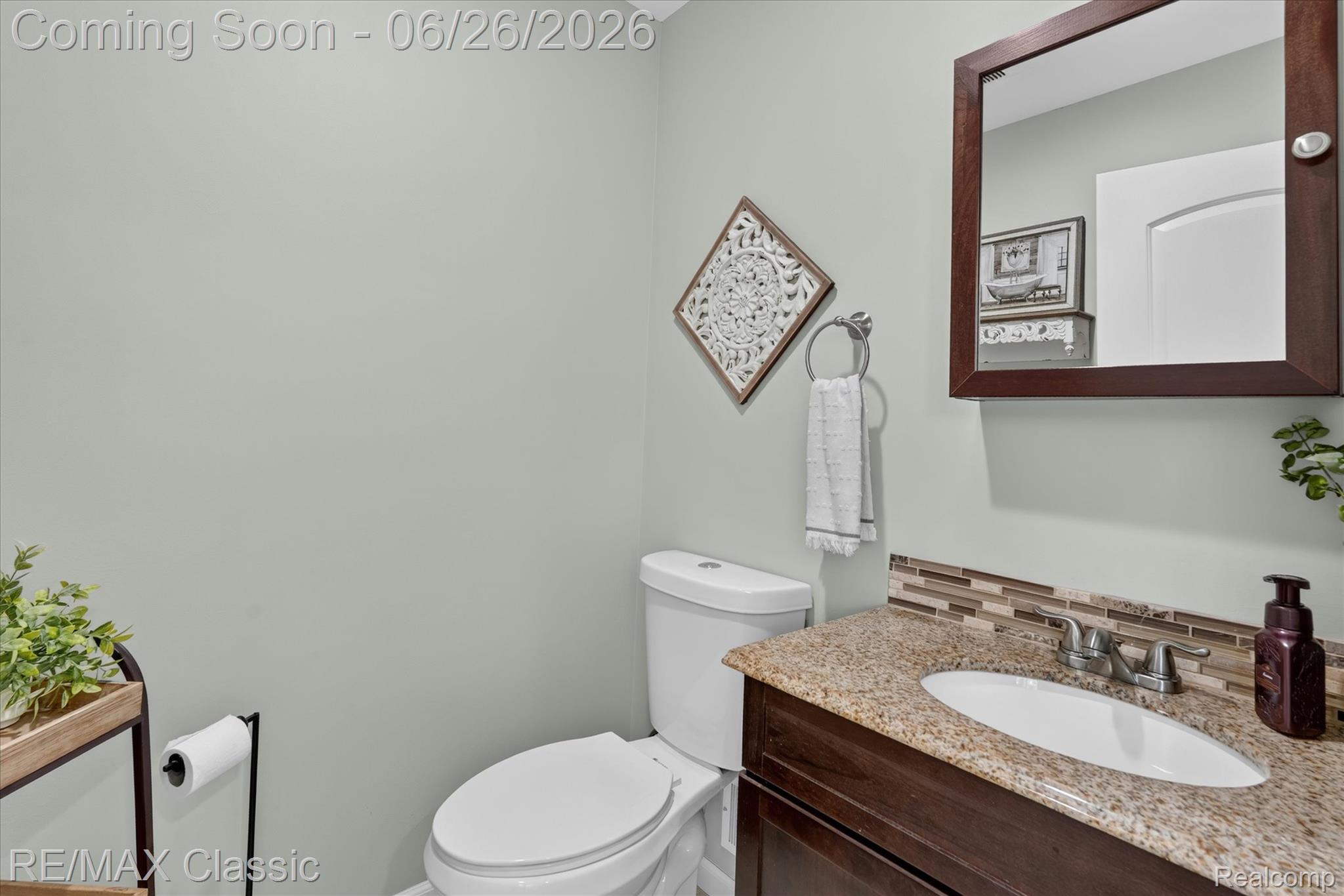 3205 North Milford Road Highland, MI 48357 - Photo 30 of 53 Vanity featuring an oval undermount sink, granite countertop, and mosaic tile backsplash