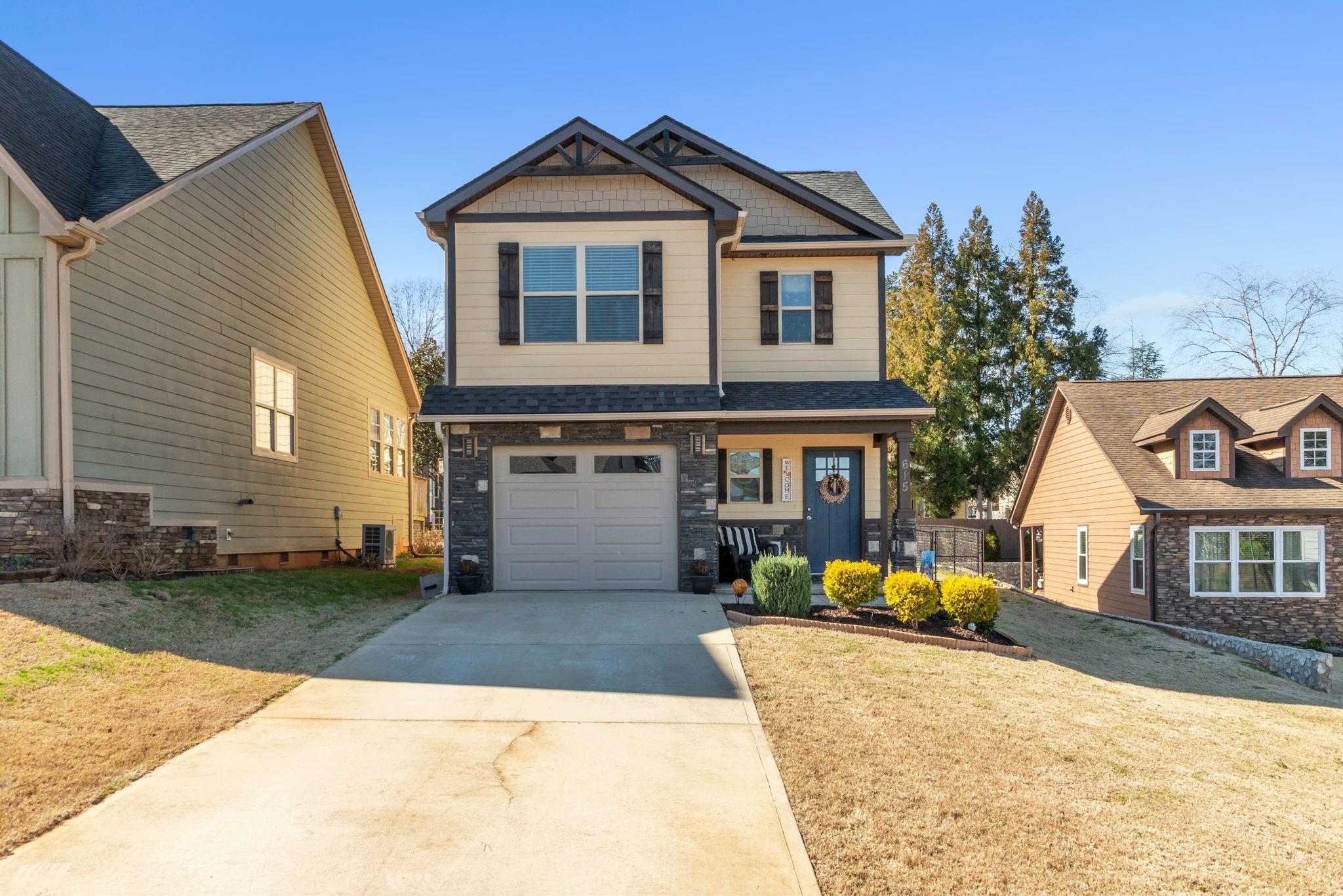a front view of a house with a yard and garage