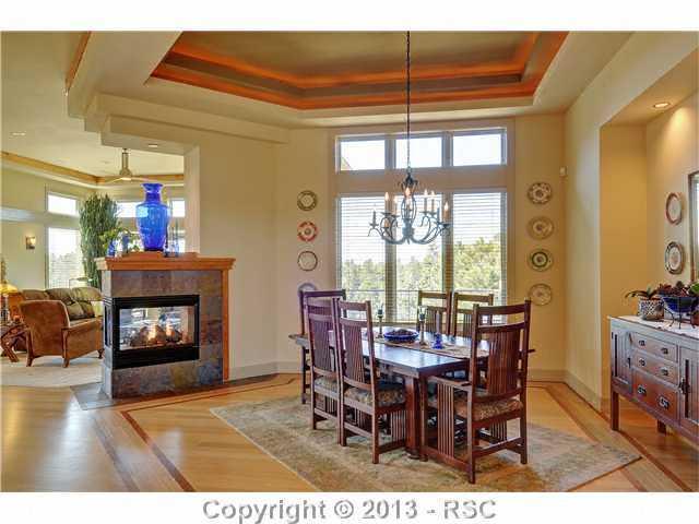 4265 Hidden Rock Road Colorado Springs, CO 80908 - Photo 13 of 25 Shared Gas Fireplace between Dining Room & Living Room/Great Room