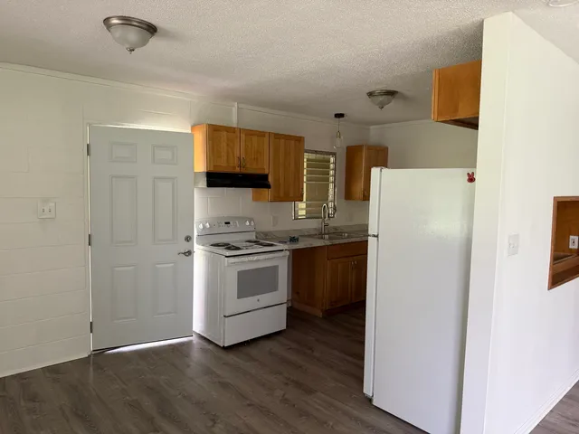 a kitchen with a refrigerator stove and a sink