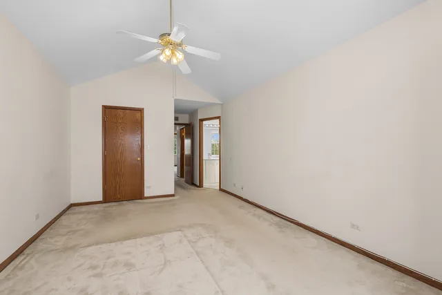 a view of an empty room with a fan