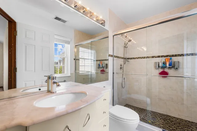 a bathroom with a sink toilet and shower