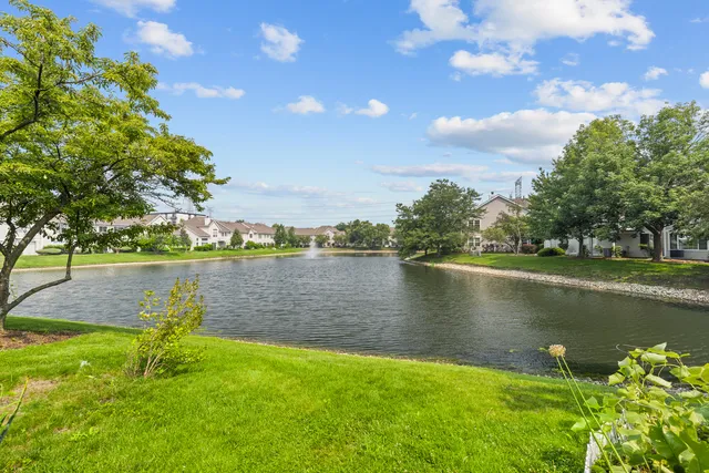 a view of a lake with houses in the back