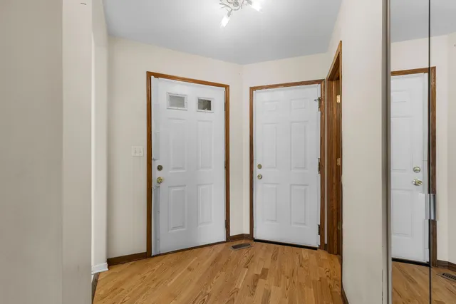 a view of a room with wooden floor and a bathroom