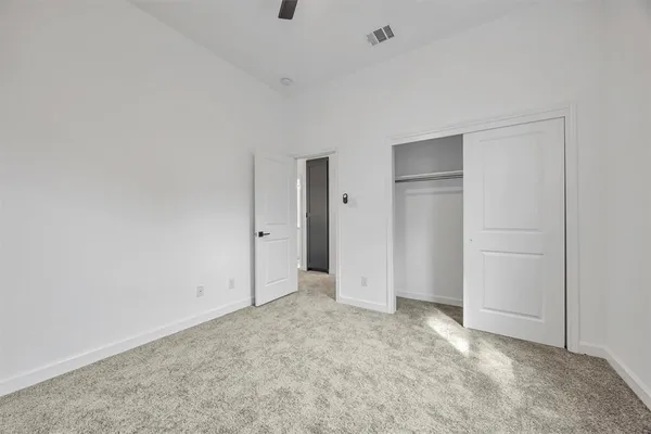 an empty room with closet area
