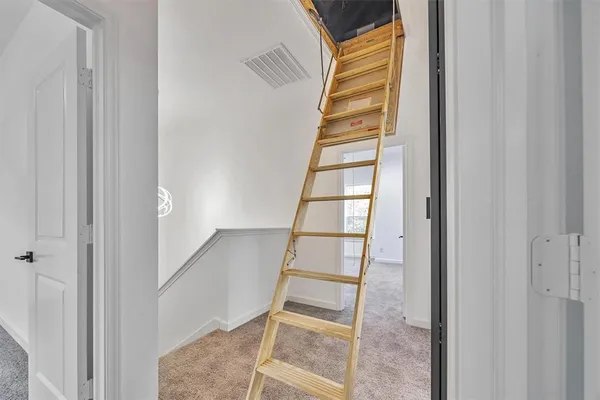 a view of staircase with white walls and windows