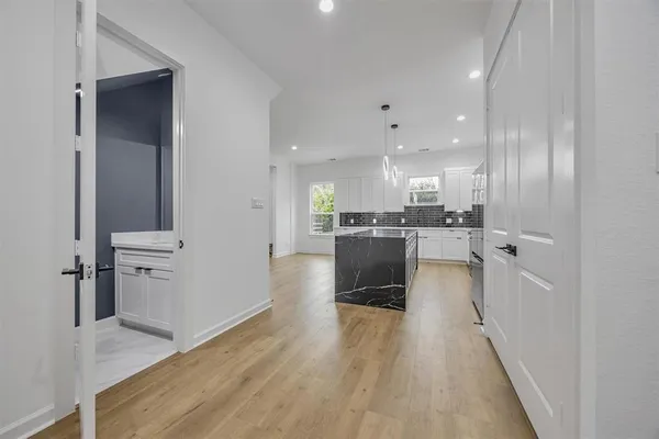 a view of a kitchen with wooden floor