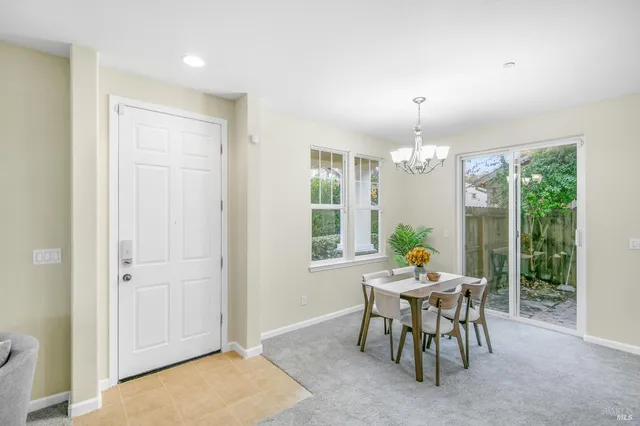 a view of a dining room with furniture and window