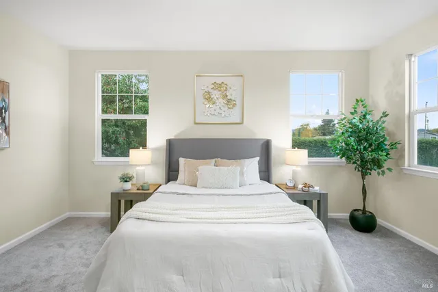 a bedroom with a large bed and a window