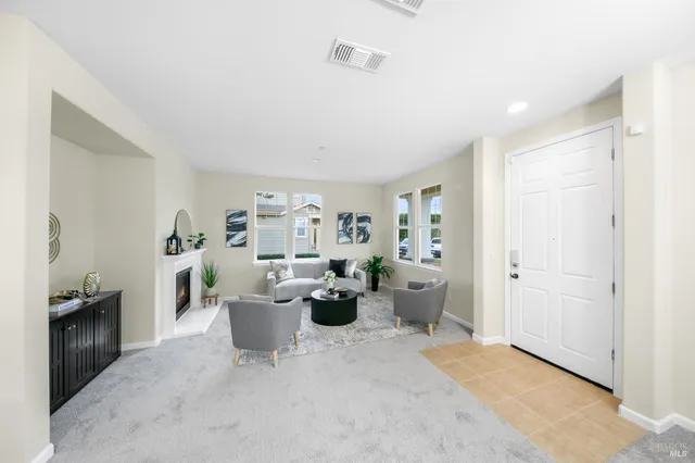 a living room with furniture and a potted plant