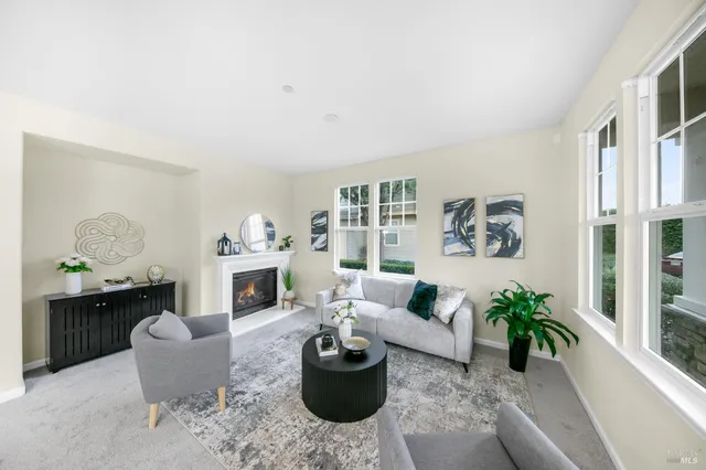 a dining room with furniture a chandelier and wooden floor