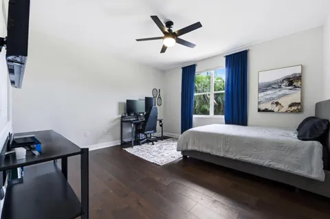 a bedroom with a bed window and a table