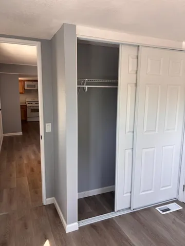 a kitchen with stainless steel appliances granite countertop a sink cabinets and wooden floor