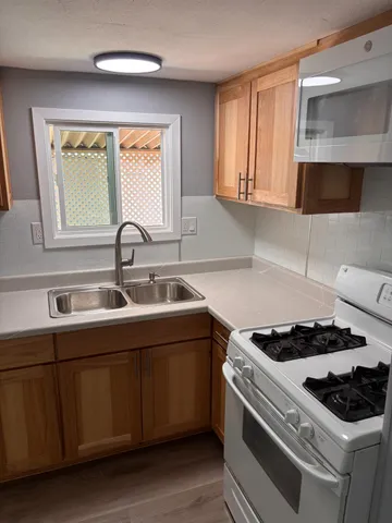 a kitchen with stainless steel appliances granite countertop a sink and cabinets