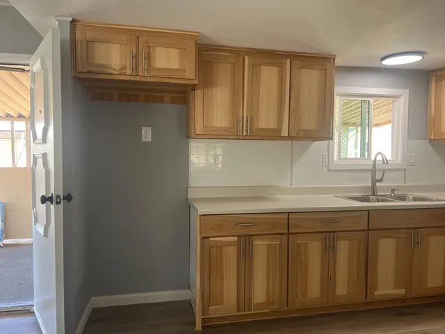 a kitchen with a sink cabinets and a window