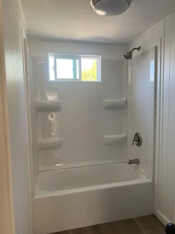 a bathroom with a bathtub and a shower