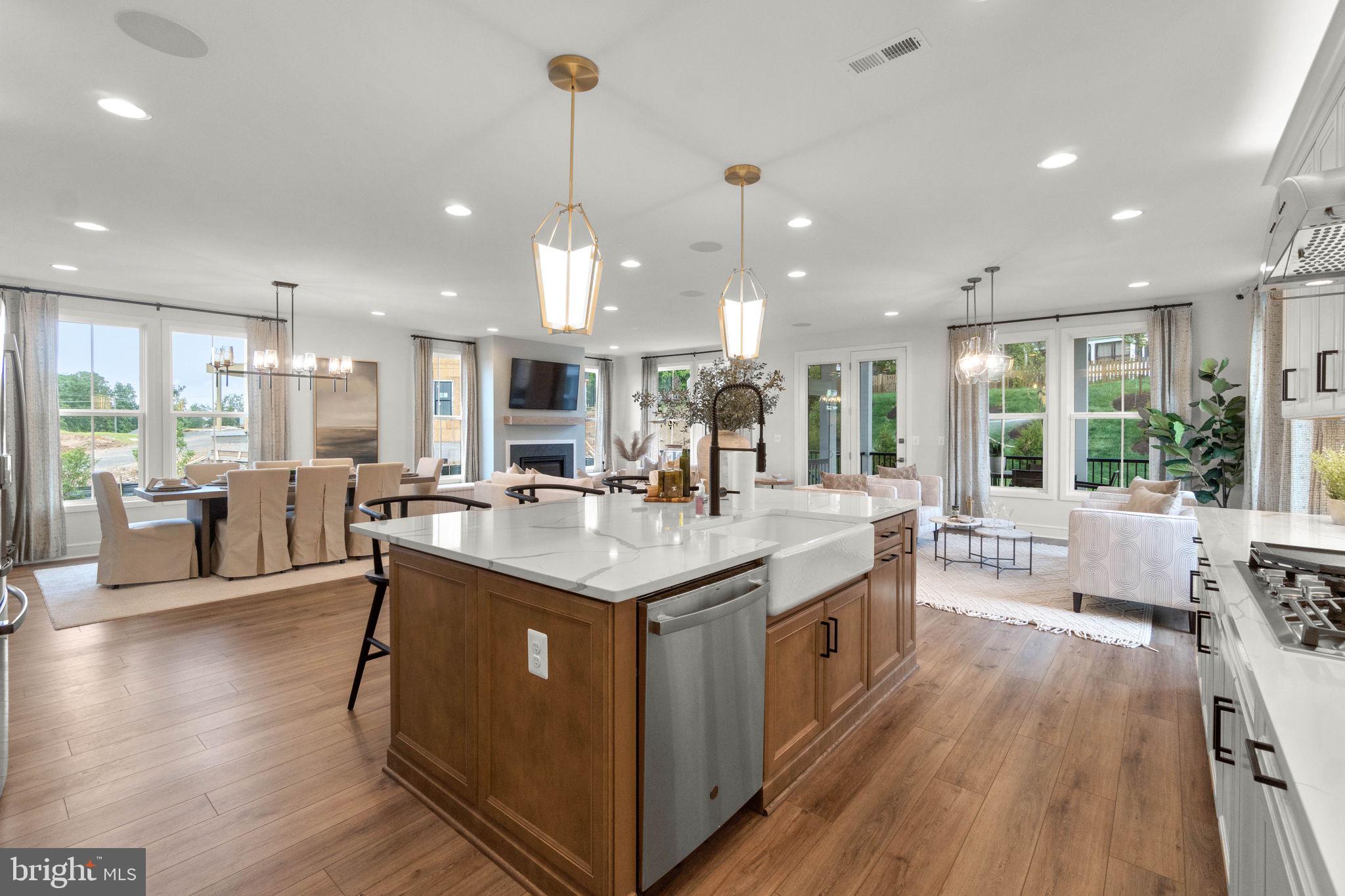 an open kitchen with kitchen island granite countertop a large center island and a wooden floor