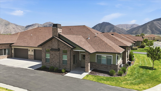 1838 West 300th Street South, Unit B Mapleton, UT 84664 - Photo 38 of 51 Brick and siding exterior featuring a prominent chimney structure and brown shingle roofing