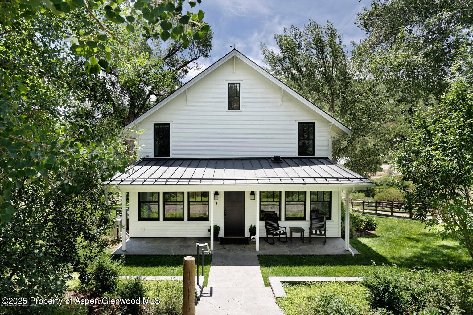 1814 Woody Creek Road Aspen, CO 81612 - Photo 13 of 52 a front view of house with a garden and patio