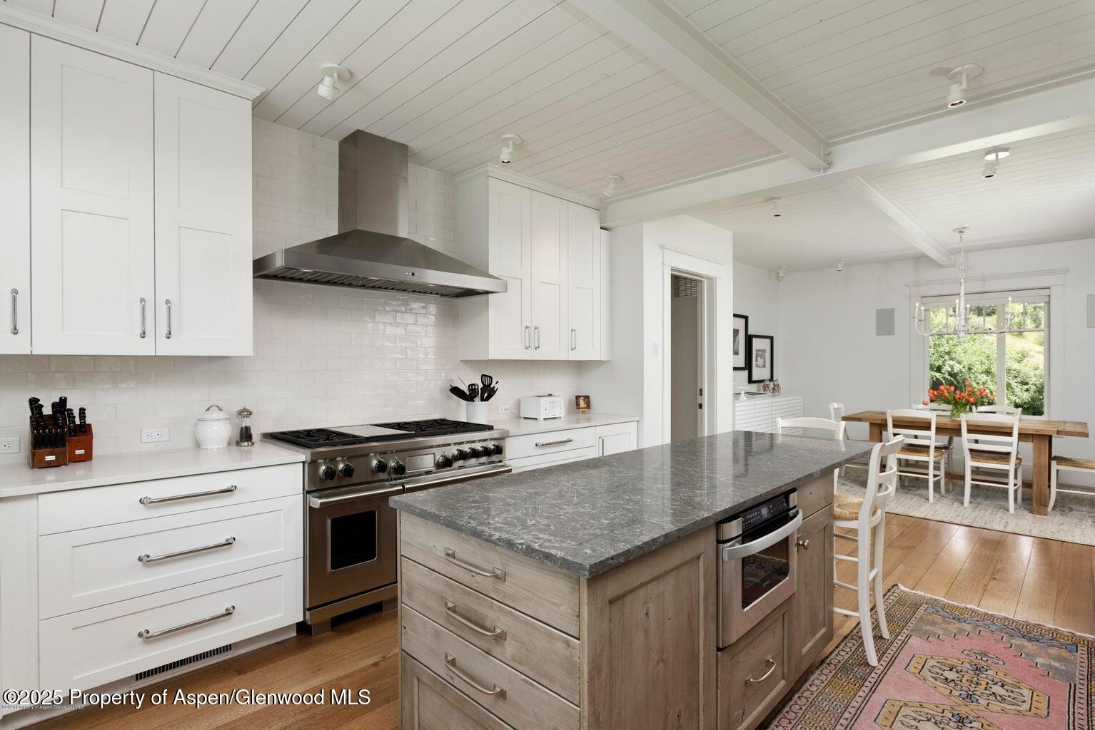 1814 Woody Creek Road Aspen, CO 81612 - Photo 15 of 52 a kitchen with granite countertop stainless steel appliances a stove a sink and cabinets