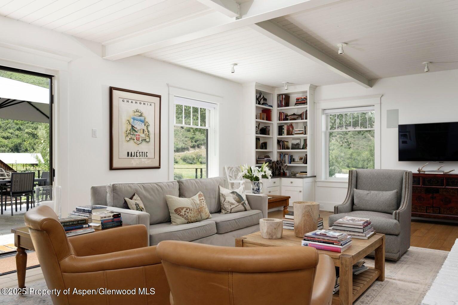 1814 Woody Creek Road Aspen, CO 81612 - Photo 18 of 52 a living room with furniture and a flat screen tv