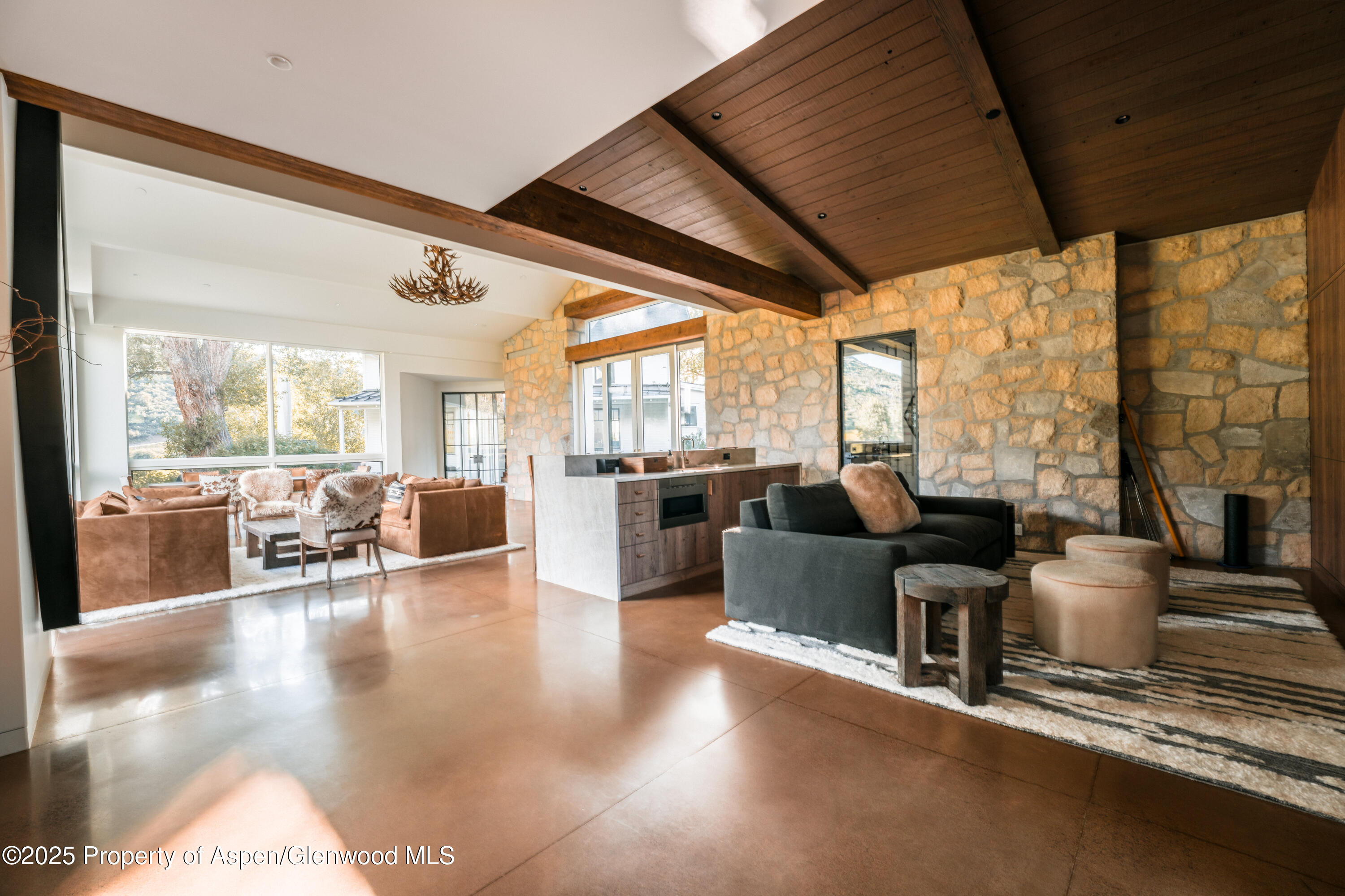 1814 Woody Creek Road Aspen, CO 81612 - Photo 20 of 52 a living room with fireplace furniture large windows and wooden floor