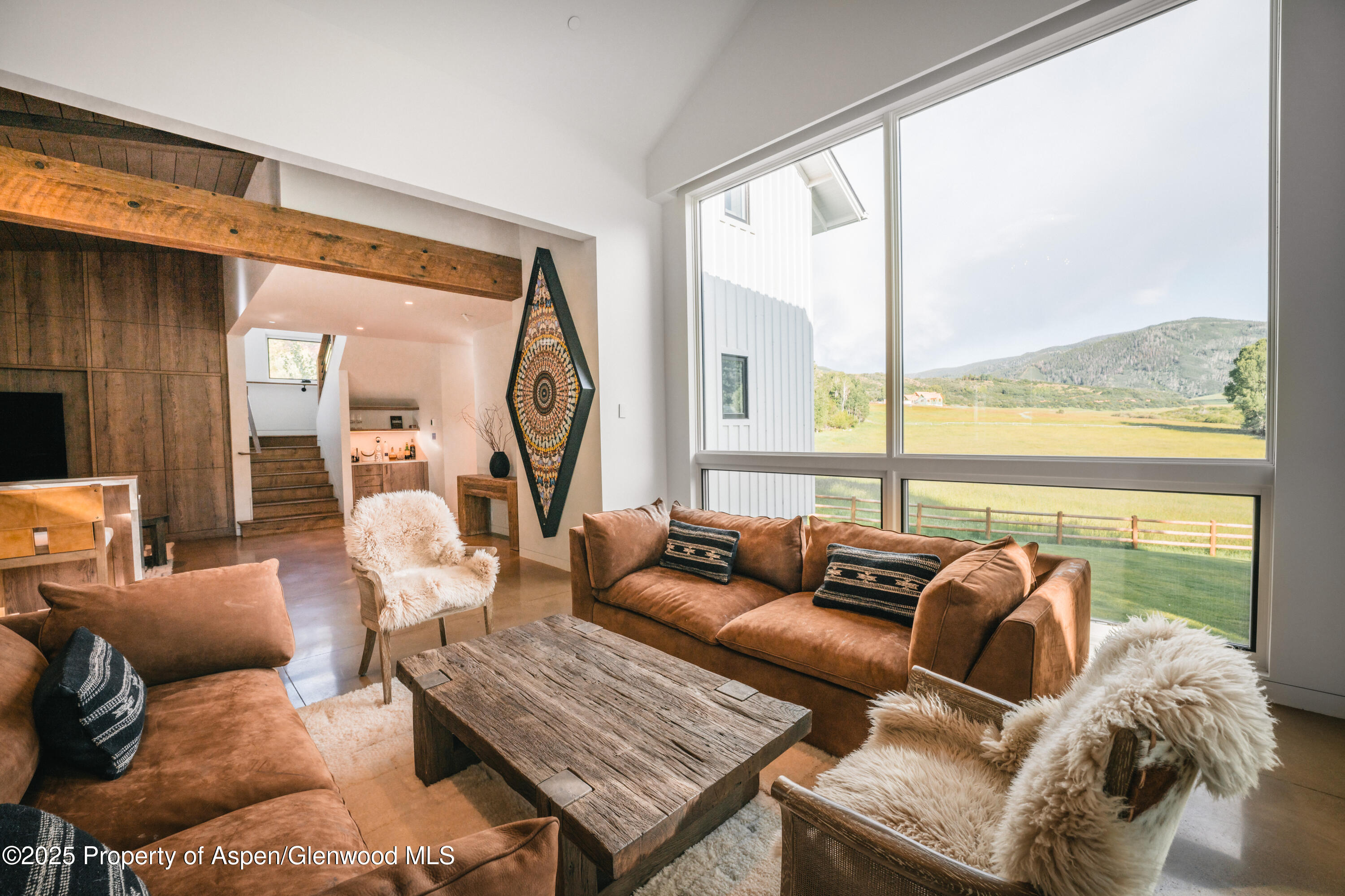 1814 Woody Creek Road Aspen, CO 81612 - Photo 22 of 52 a living room with furniture and floor to ceiling windows