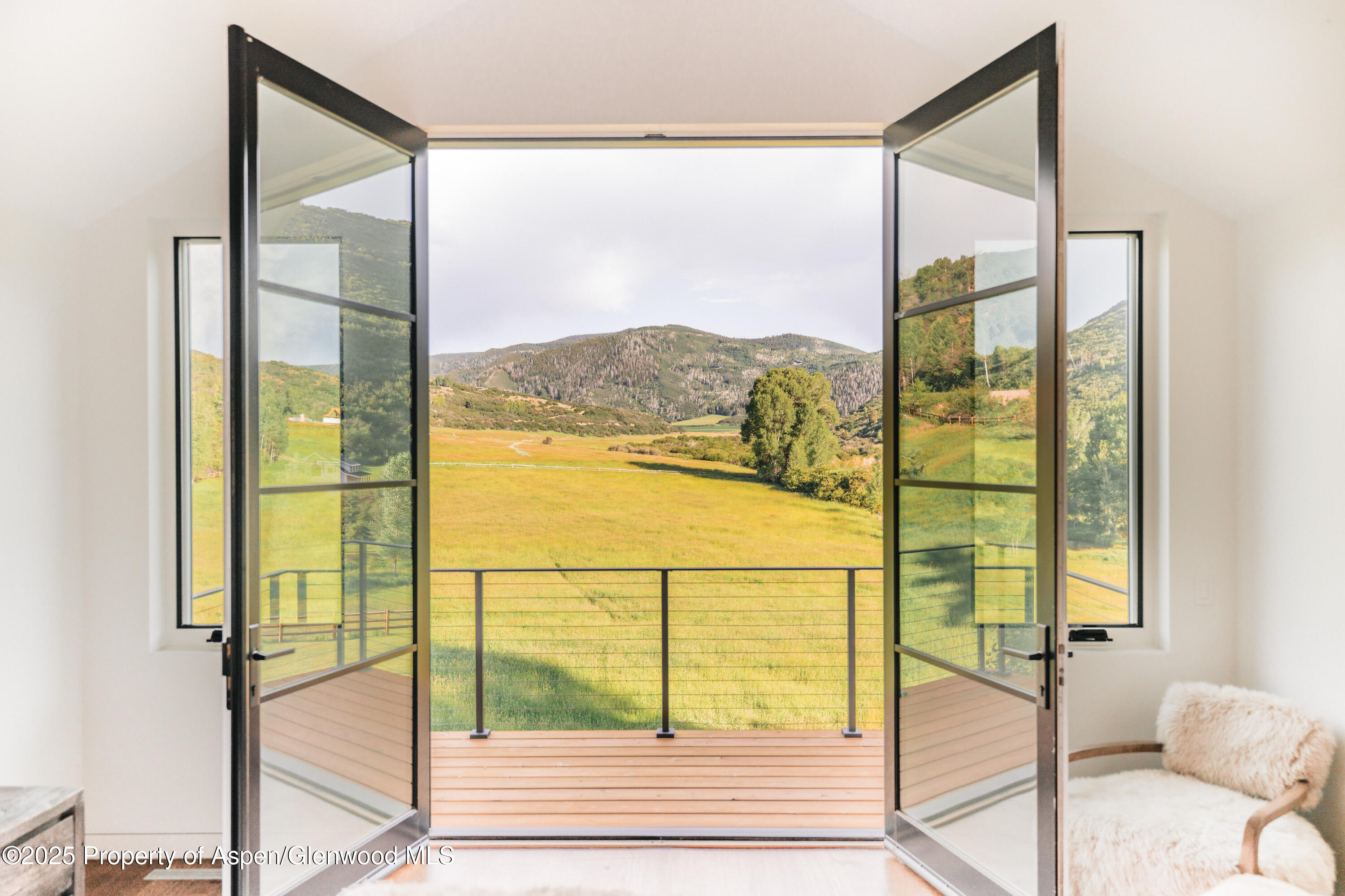 1814 Woody Creek Road Aspen, CO 81612 - Photo 25 of 52 a view of a balcony with a floor to ceiling window