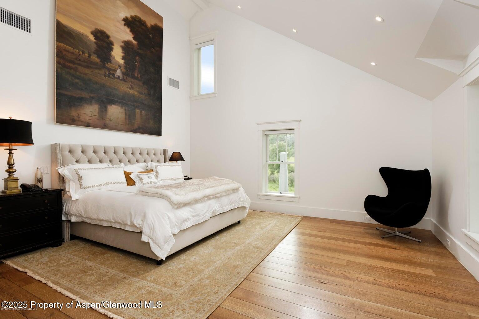 1814 Woody Creek Road Aspen, CO 81612 - Photo 26 of 52 a bedroom with a bed and a painting on the wall