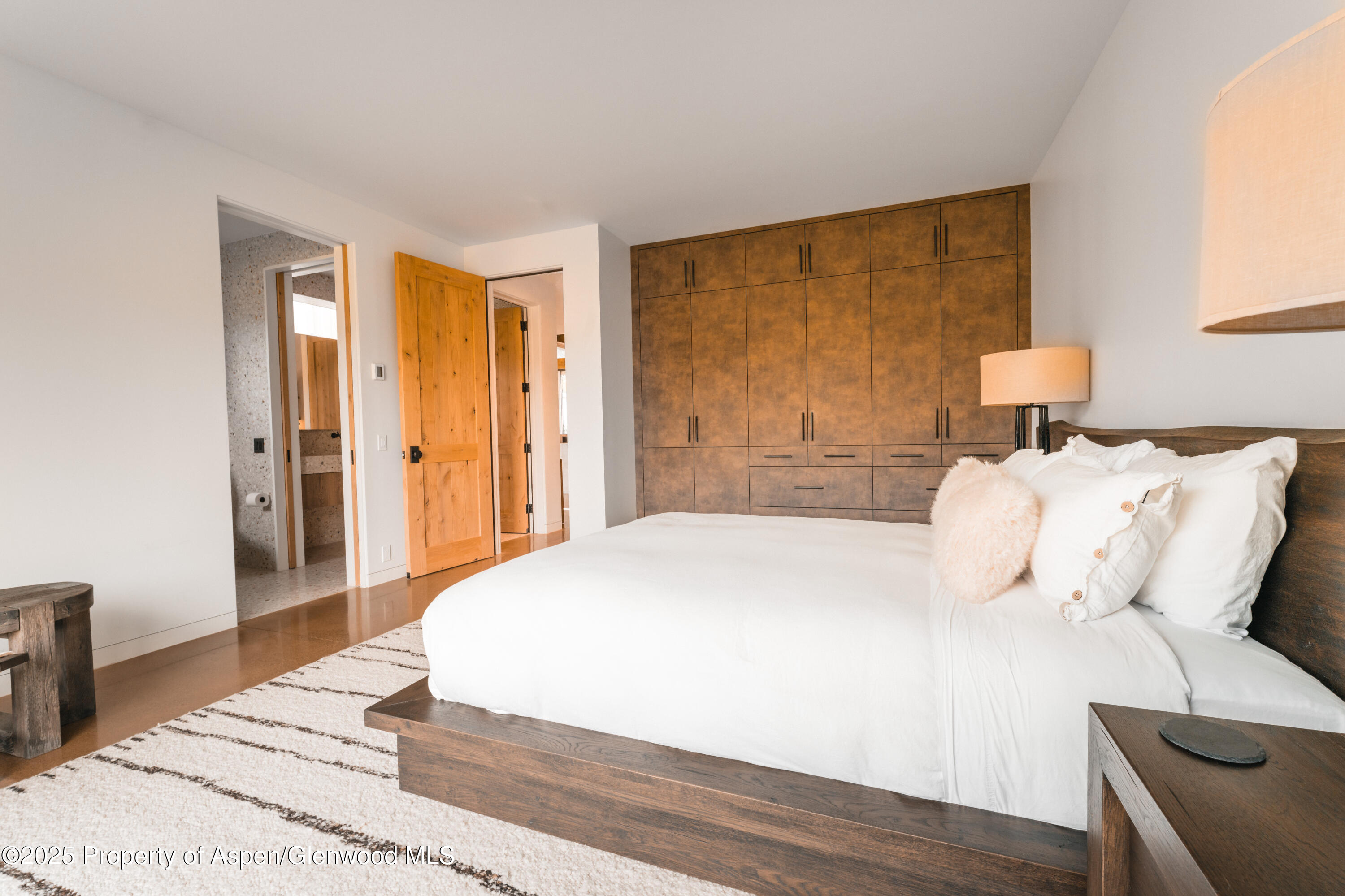 1814 Woody Creek Road Aspen, CO 81612 - Photo 29 of 52 a bedroom with a bed and wooden floor