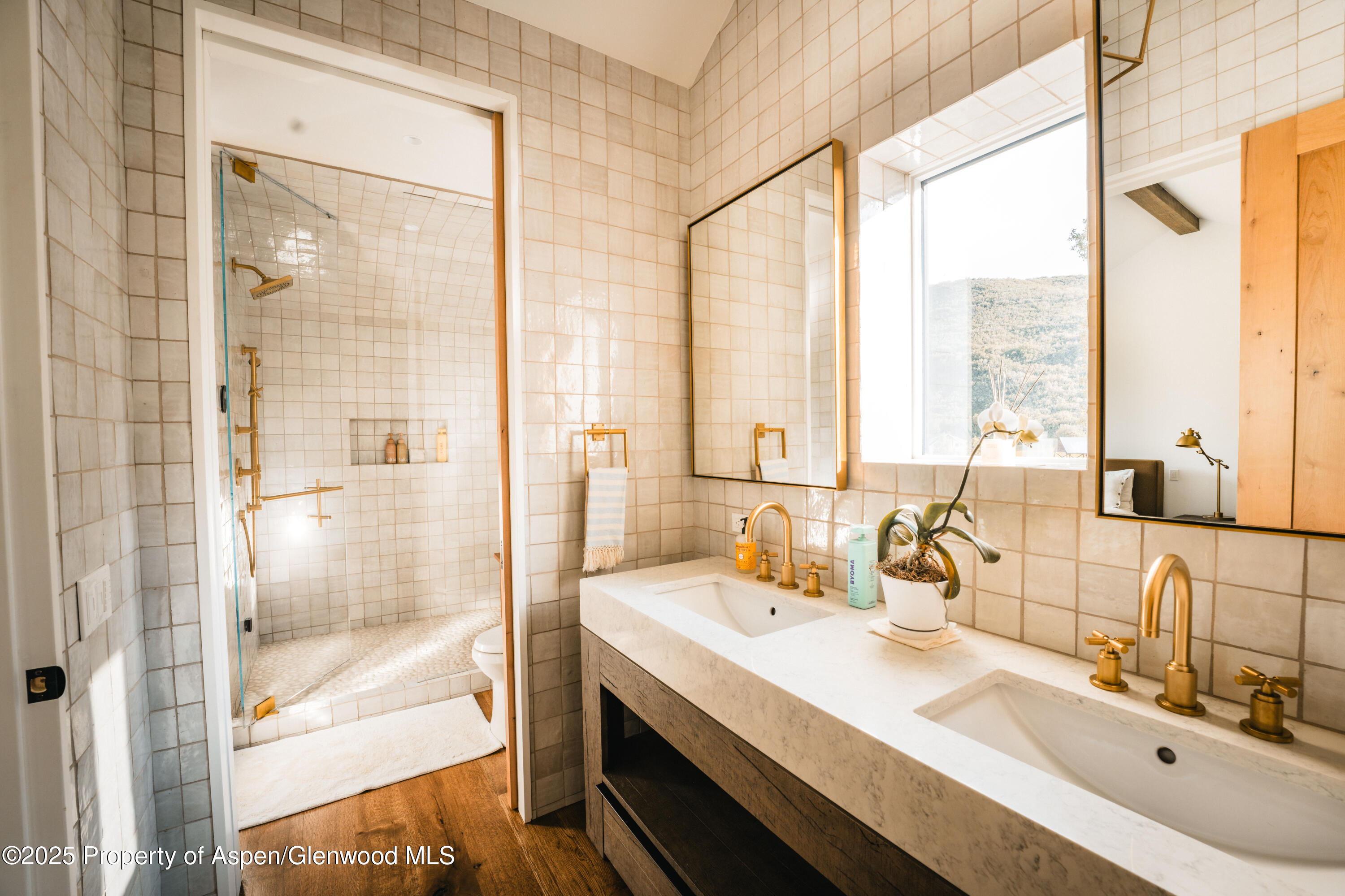 1814 Woody Creek Road Aspen, CO 81612 - Photo 30 of 52 a bathroom with a double vanity sink mirror and next to a window