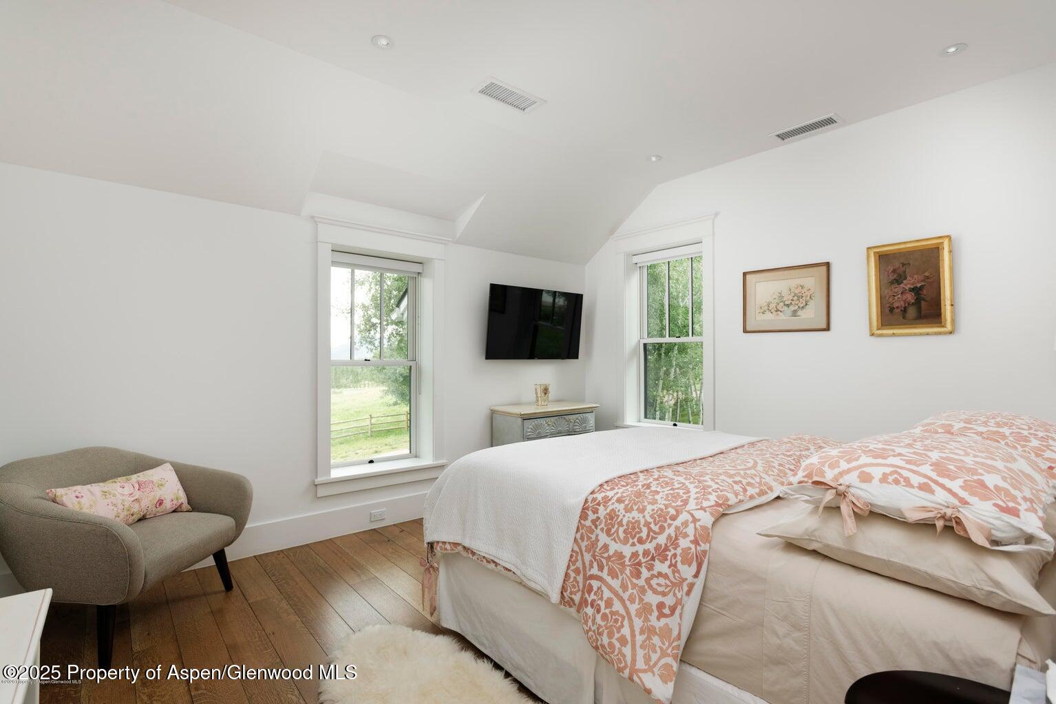 1814 Woody Creek Road Aspen, CO 81612 - Photo 33 of 52 a bedroom with a bed and a television