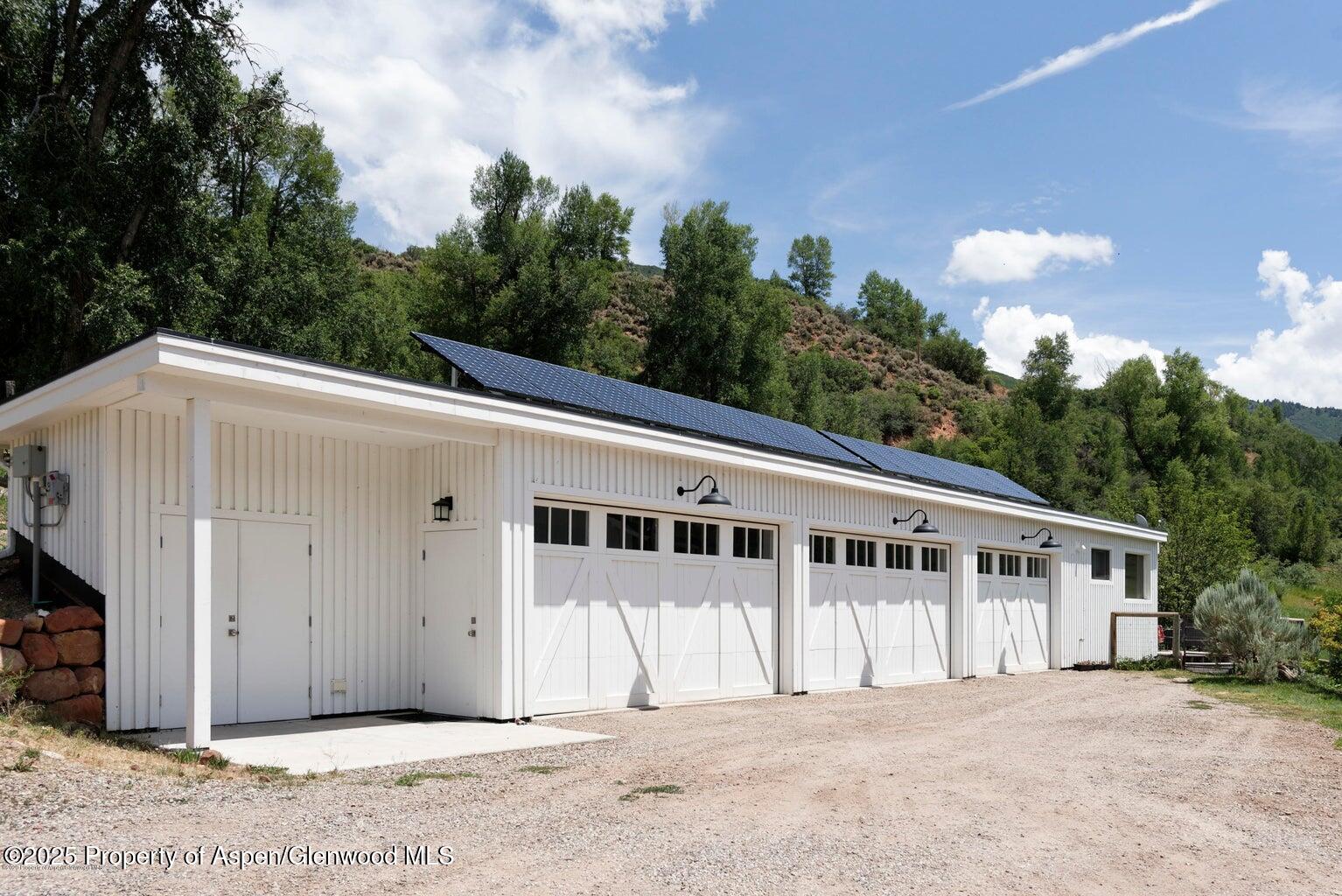 1814 Woody Creek Road Aspen, CO 81612 - Photo 35 of 52 a view of a house with a backyard