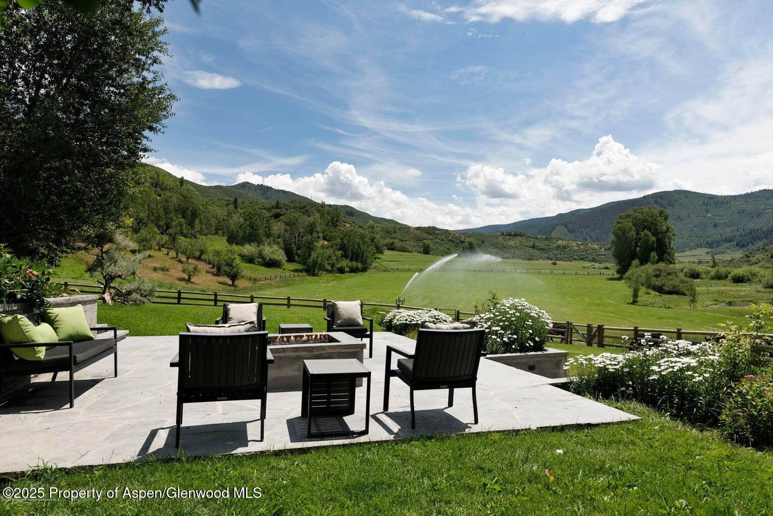 1814 Woody Creek Road Aspen, CO 81612 - Photo 36 of 52 a view of a patio with couches table and chairs and garden view