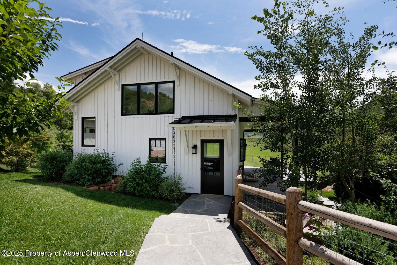 1814 Woody Creek Road Aspen, CO 81612 - Photo 39 of 52 a front view of house with yard and green space